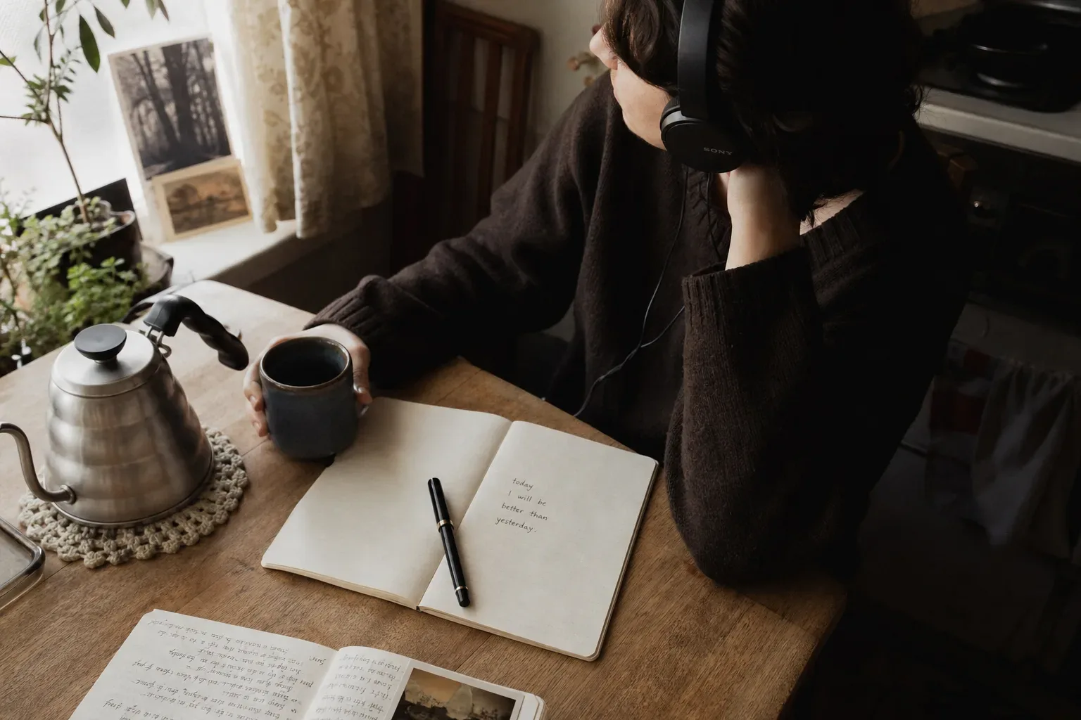 Person listening quietly beside a morning kettle